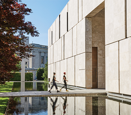 Two people walking into the museum