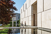 Two people walking into the museum