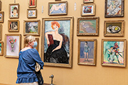 A woman looking at a painting