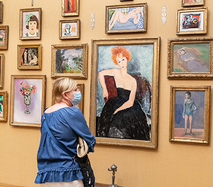 A woman looking at a painting